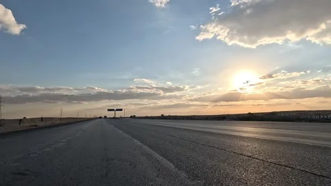 Open desert highway exploration along Cairo Fayoum Desert Road endless views Stock Footage 330078309