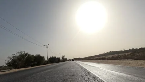 Open desert road experience along Cairo Fayoum Desert Road endless horizons Stock Footage 329830788
