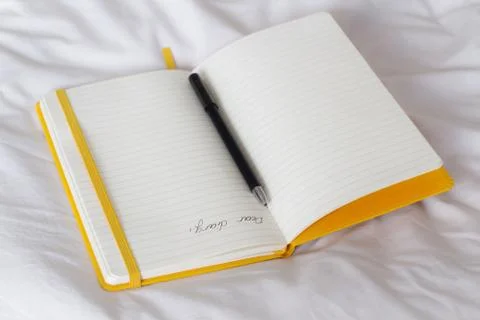 Open diary on a bed Stock Photos