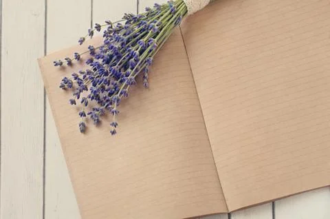 Open diary notes on the wooden table and flowers forest Lavander Foto stock