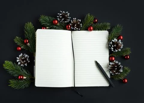 Open diary for plans for the new year with pen decorated with spruce branches Stock Photos
