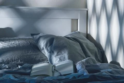Open diary to write on the bed with blue textiles in the moonlight. Evening Stock Photos