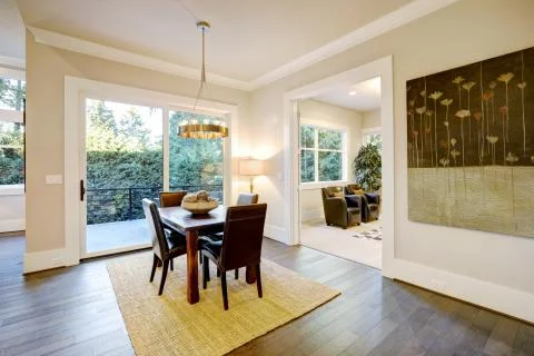 Open dining space design with soft beige walls and rustic table  Stock Photos