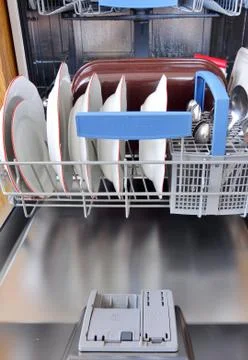 Open dishwasher with clean dishes in kitchen Stock Photos