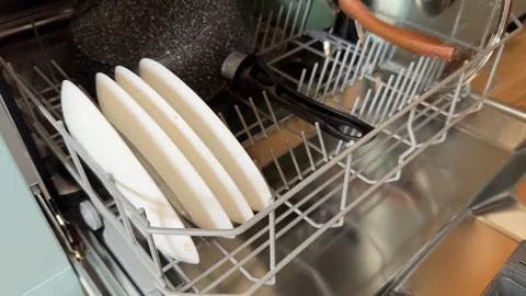 An open dishwasher packed with various kitchen items Stock Footage 303970970