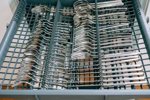 Open dishwasher with a pull-out compartment for clean spoons and forks 写真素材