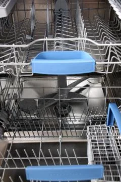 Open dishwasher without dishes in kitchen Stock Photos