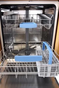 Open dishwasher without dishes in kitchen Stock Photos