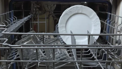 Open door of built-in dishwasher. Plates and dishes in the dishwasher. Stock Footage 225146310