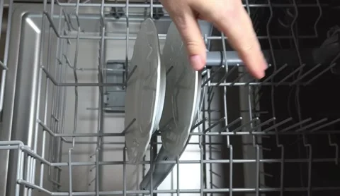 Open door of built-in dishwasher. Plates and dishes in the dishwasher. Stock Footage 225146326