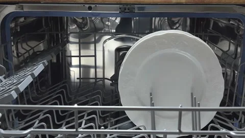 Open door of built-in dishwasher.  Plates and dishes in the dishwasher. Stock Footage 225146456