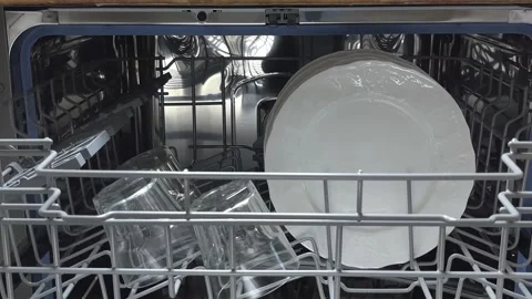 Open door of built-in dishwasher. Plates and dishes in the dishwasher. Stock Footage 225146624