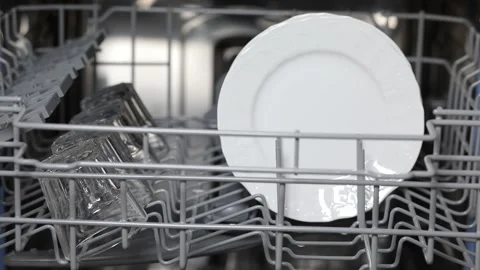 Open door of built-in dishwasher. Plates and dishes in the dishwasher. Stock Footage 229711132