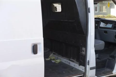Open door exposes cargo space and driver area in urban setting Stock Photos