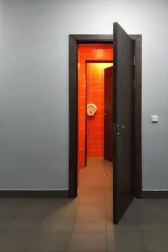 Open the door on gray wall. Stock Photos