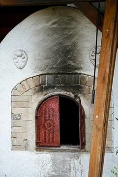 Open door in an old oven for baking bread in close-up. Stock Photos
