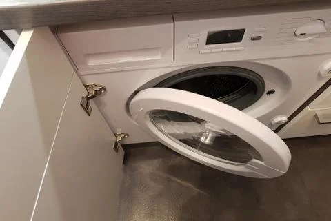 Open door of a washing machine Stock Photos