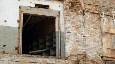 Open doorway on the second floor of an old weathered industrial building. 4k60p Stock Footage 130148915
