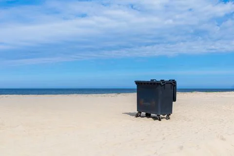Open dumpster on a sandy beach Stock Photos