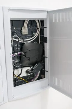 Open electrical distribution box with cables and network equipment Stock Photos