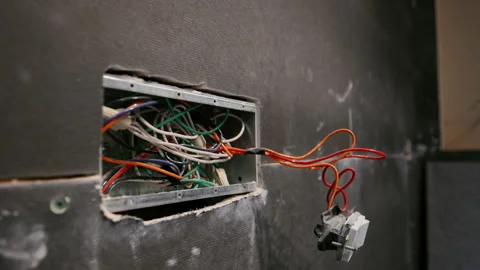 Open electrical wall box with exposed wires during installation or repair. Stock Footage 334062995