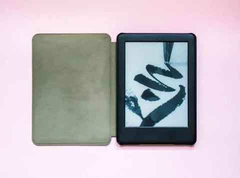 Open electronic book on pink background Stock Photos