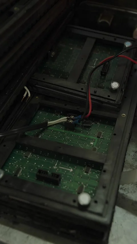 An open electronic module reveals green circuit boards and wiring Stock Footage 340153997