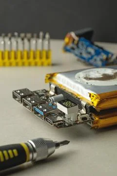 Open electronics reveal a compact board and repair tools Fotos de archivo