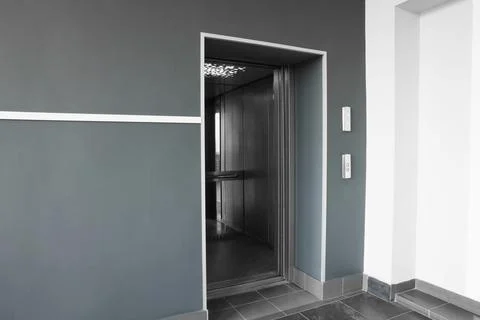 Open elevator`s cabin with big mirror in hall Fotos de archivo