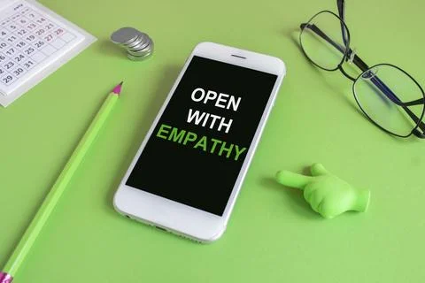 Open with empathy message written on the mobile phone screen. Stock Photos