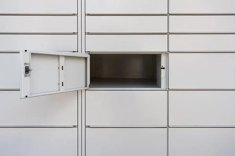 Open empty cell of an automated parcel locker for delivery service Stock Photos