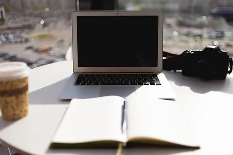 An open empty diary on the background of a laptop at the workplace in a brigh Stock Photos