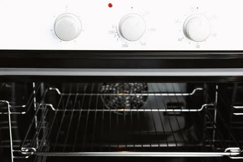 Open empty electric oven with rack, closeup Stock Photos
