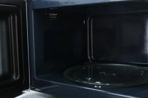 Open empty microwave oven, closeup. Inside view 스톡 사진