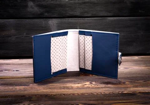 Open empty new blue leather wallet on rustic wood background Stock Photos