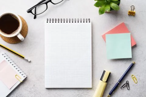 An open empty notebook, stationery and cup of coffee on a desk. Stock Photos