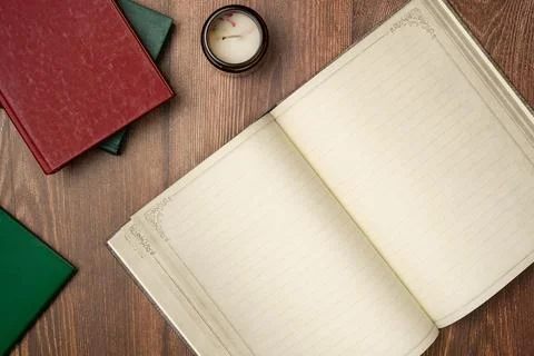 Open empty notebook in vintage style with books on wooden background from abo Stock Photos