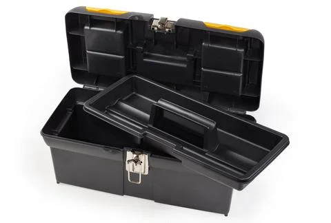 Open empty plastic portable multi-compartment toolbox with removed tray Stock Photos