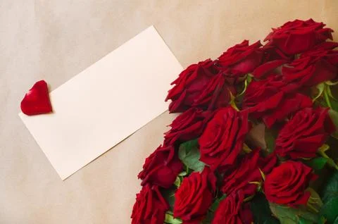 Open empty postal envelope and bouquet of roses Stock Photos