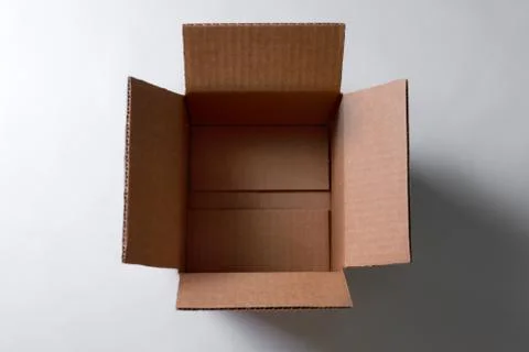 Open empty rectangular cardboard box on grey background. Mockup for design an Stock Photos