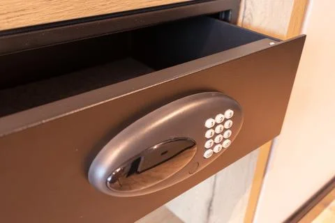 Open empty safe in hotel room or home. Safety box drawer with modern electronic Stock Photos