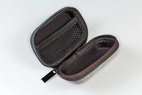 Open empty small plastic case with zipper on gray background Stock Photos