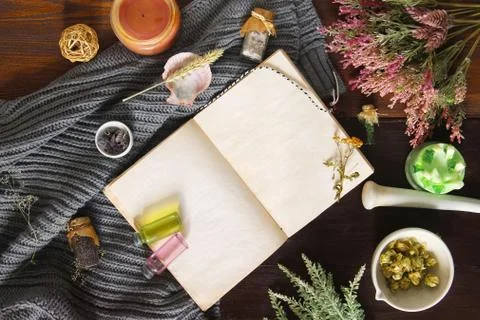 An open empty vintage notebook surrounded by herbs, alchemy appliances, potio Stock Photos