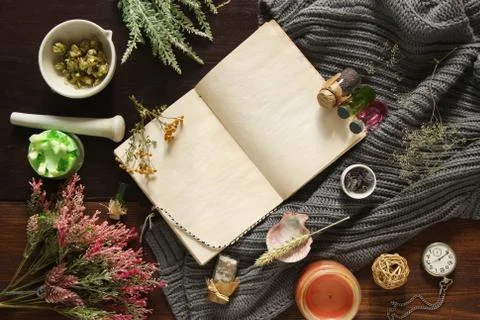 An open empty vintage notebook surrounded by herbs, alchemy appliances, potio Stock Photos