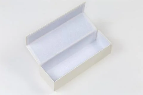 Open empty white hard spectacle-case on a white surface Foto stock