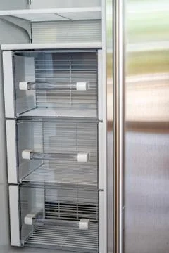Open empty white refrigerator. Side View of Stainless Steel Double Door Foto stock