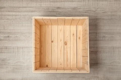 Open empty wooden crate on light background, top view Stock Photos