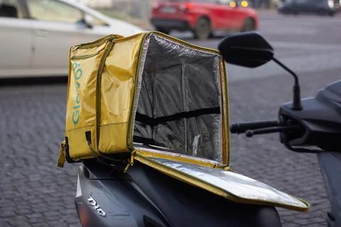Open empty yellow thermo bag for delivery food, drink with Glovo logo Stock Photos