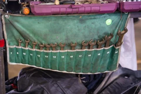 Open end wrench set arranged by size in tool organizer at auto repair shop Stock Photos