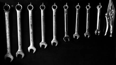 Open End Wrenches set hanging on black board. Stock Photos